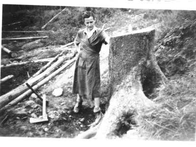 Oma by the tree stump assigned to the family for wood supplies. © Anemone Rüger